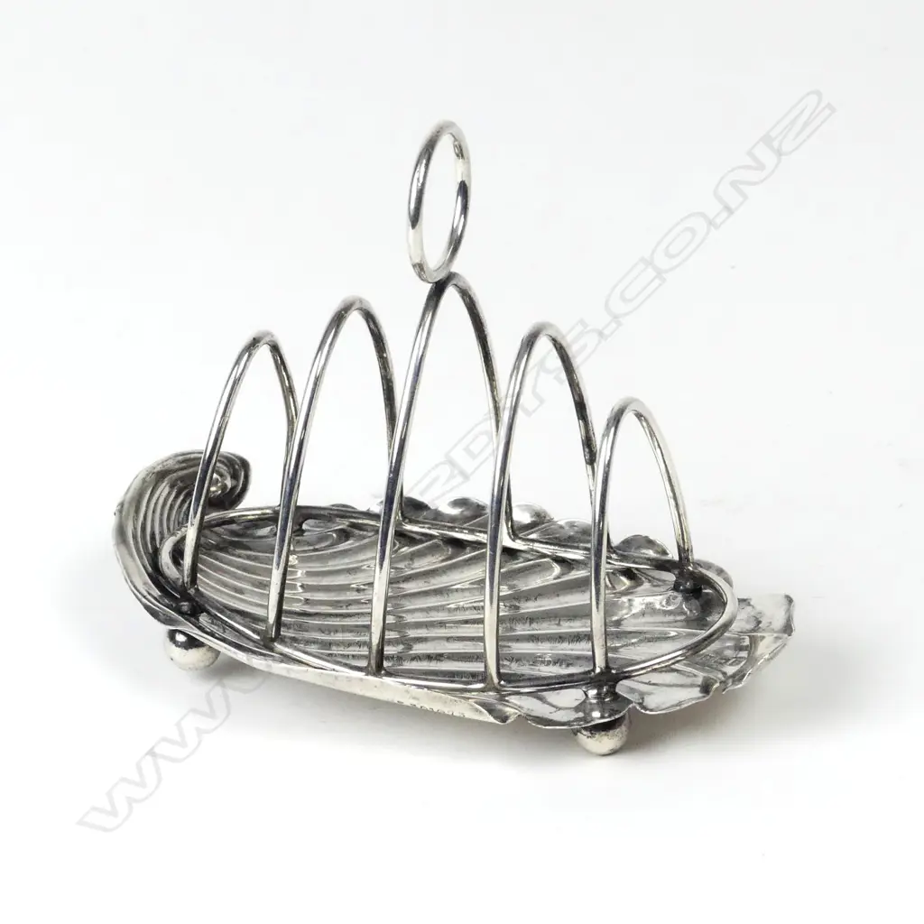 An Edwardian silver four-slice toast rack Image 1++
