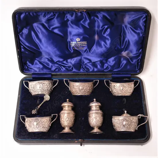A late Victorian seven-piece cased silver horse-racing club prize condiment set
