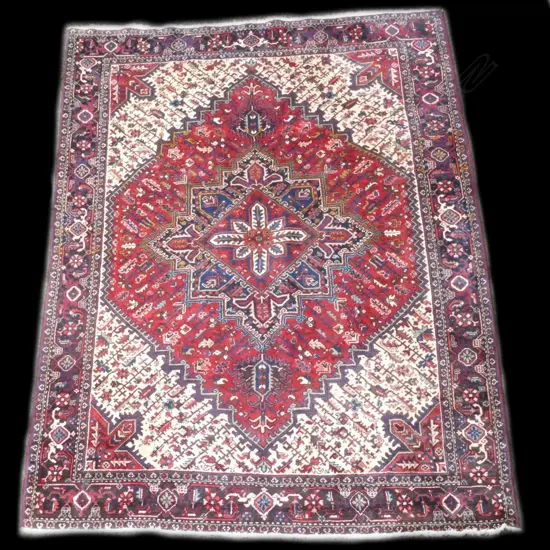 A large and heavy quality Heriz carpet