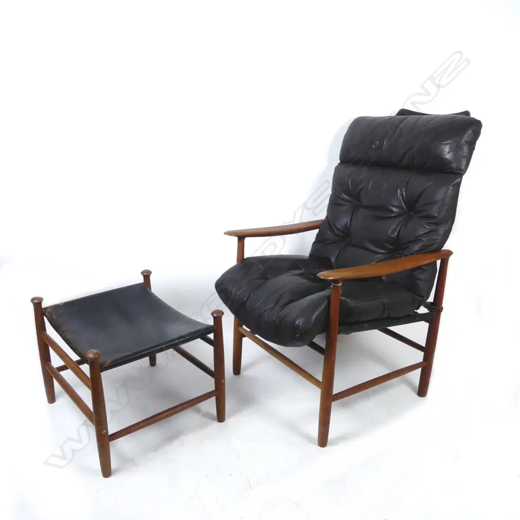 A teak framed high-back armchair with black leather seat and pivot mounted back Image 1++