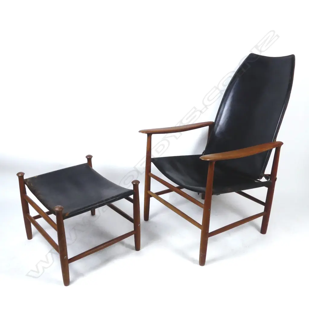 A teak framed high-back armchair with black leather seat and pivot mounted back Image 1++