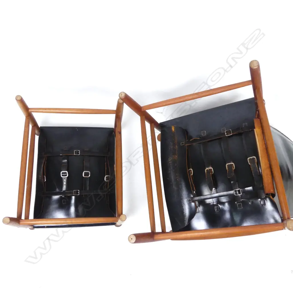 A teak framed high-back armchair with black leather seat and pivot mounted back Image 1++