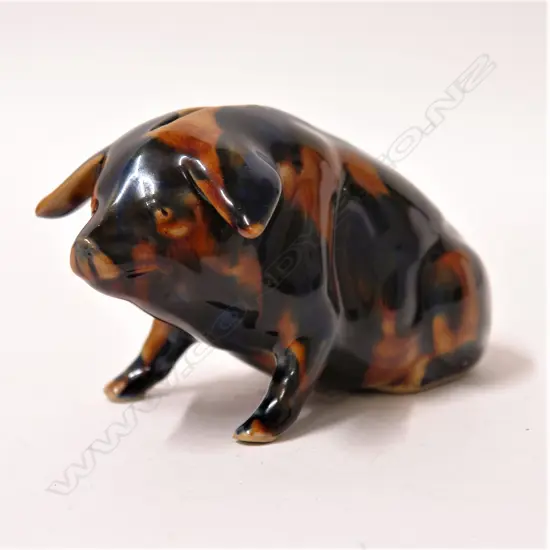 An early 20thC majolica glazed pottery seated pig money box