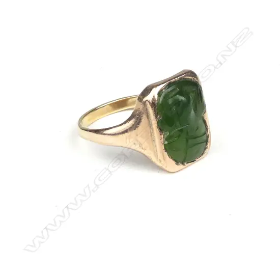 A 9ct. rose gold greenstone tiki mounted signet ring