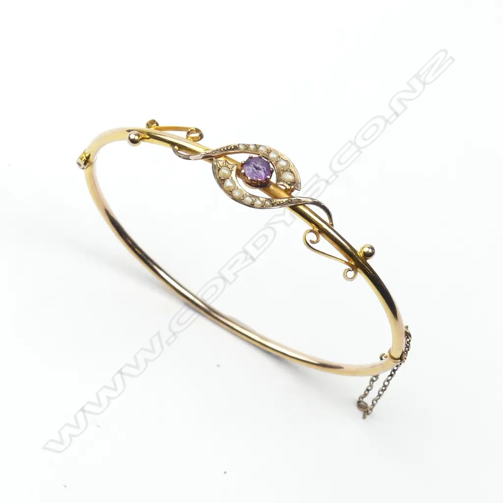 A 9ct. rose gold amethyst and seed pearl hinged bangle Image 1++