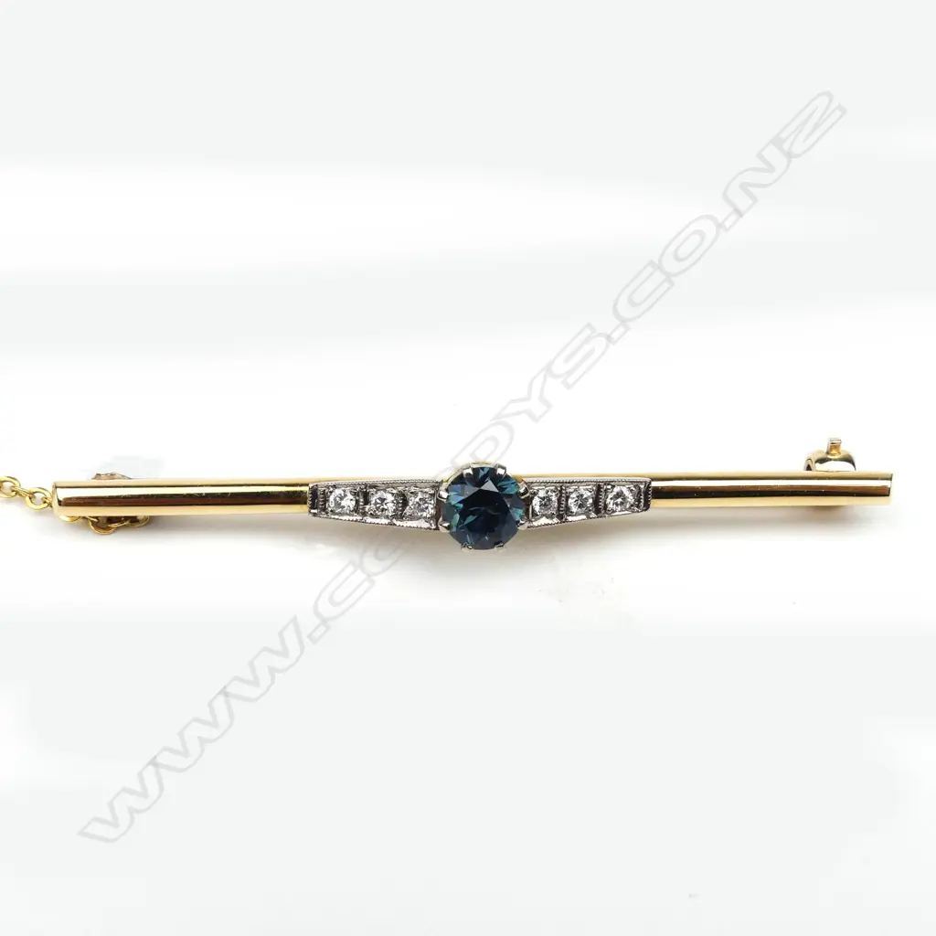 An 18ct yellow and white gold sapphire and diamond bar brooch Image 1++