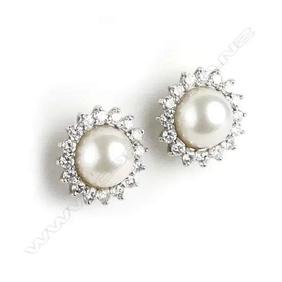 A pair of handmade platinum pearl and diamond cluster stud earrings