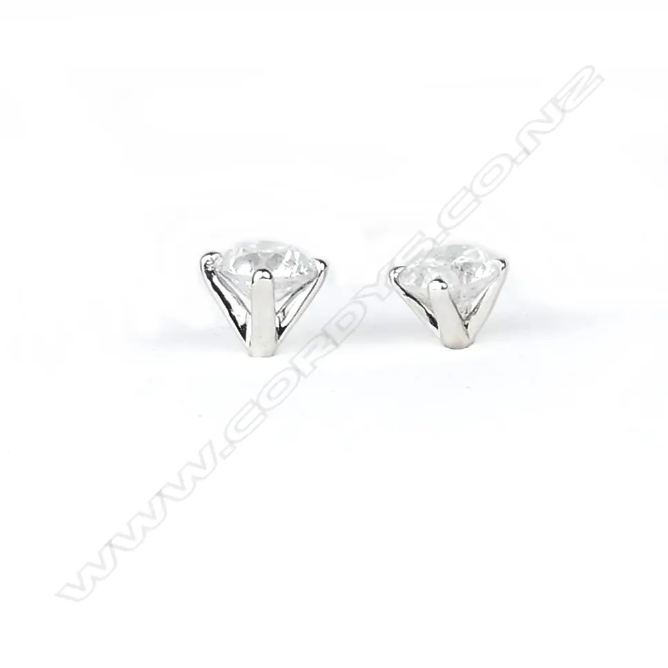 A pair of 14ct white gold and diamond stud earrings Image 1++