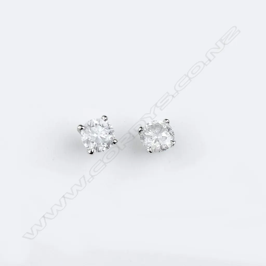 A pair of 14ct white gold and diamond stud earrings Image 1++