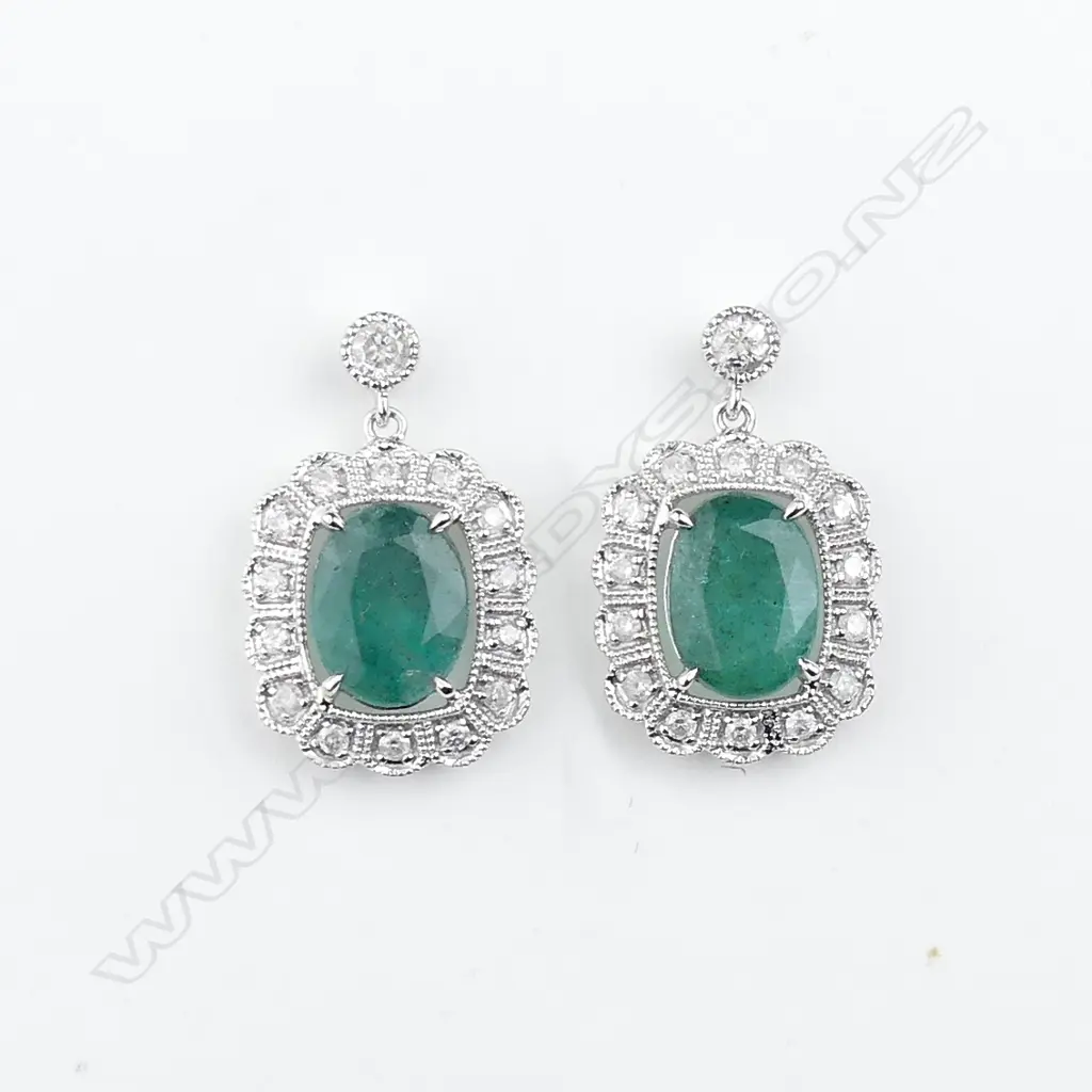 A pair of 14ct white gold emerald and diamond earrings Image 1++