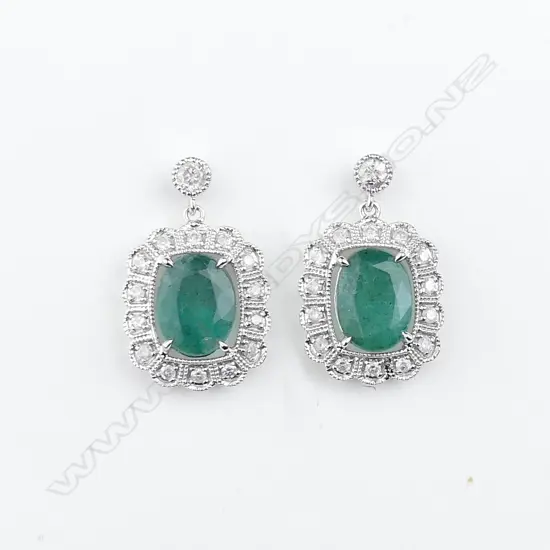 A pair of 14ct white gold emerald and diamond earrings