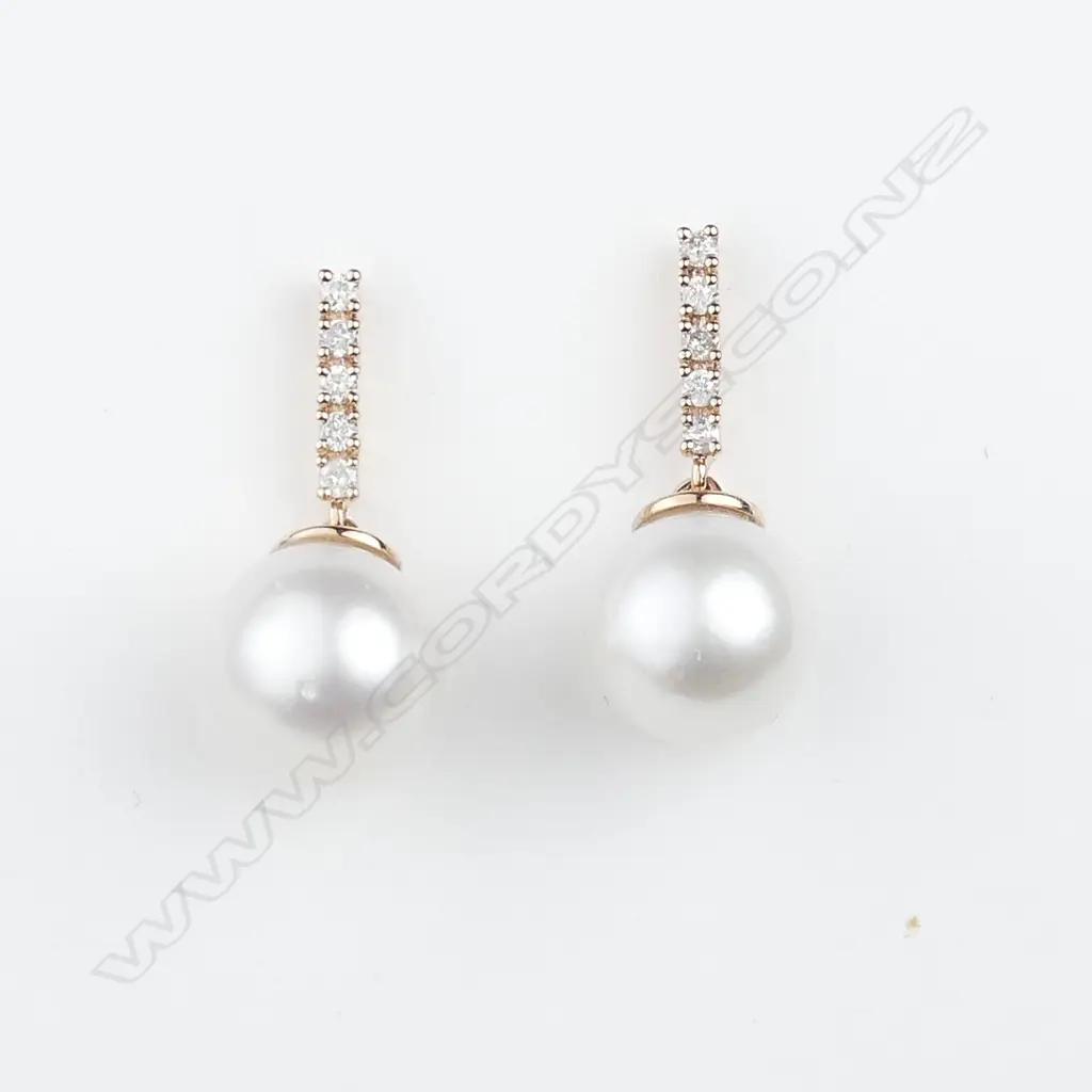 A pair of 14ct rose gold pearl and diamond earrings Image 1++