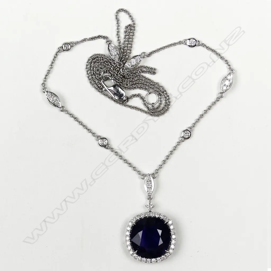 An 18ct white gold sapphire and diamond pendant Image 1++