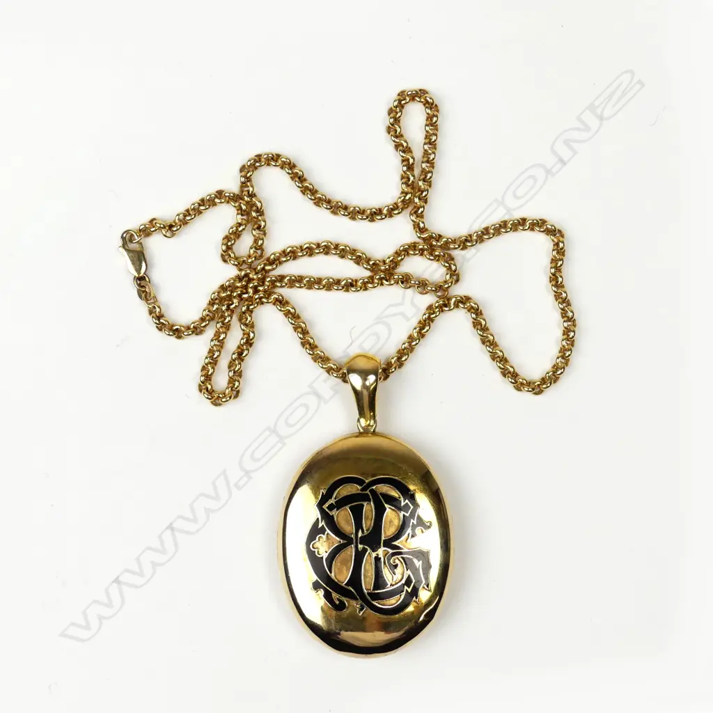 An impressive 18ct. yellow gold and enamelled locket on a modern 9ct. yellow gold chain Image 1++