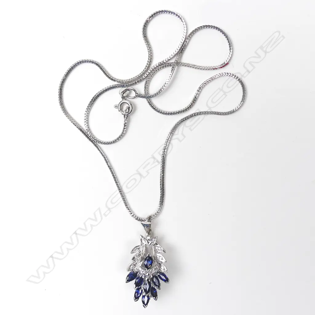 A 9ct white gold sapphire and diamond pendant/brooch on 18ct white gold chain Image 1++