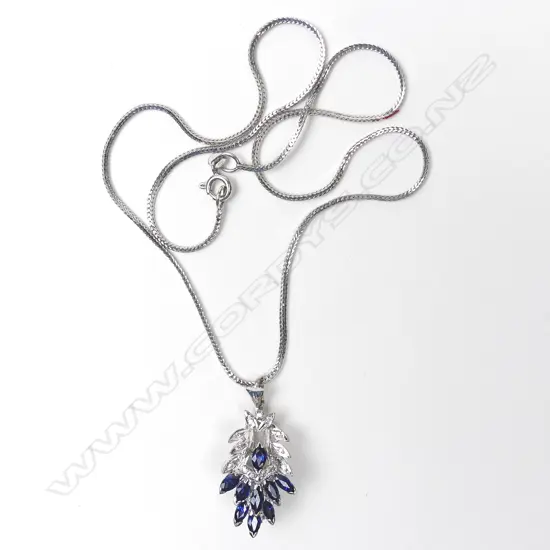 A 9ct white gold sapphire and diamond pendant/brooch on 18ct white gold chain