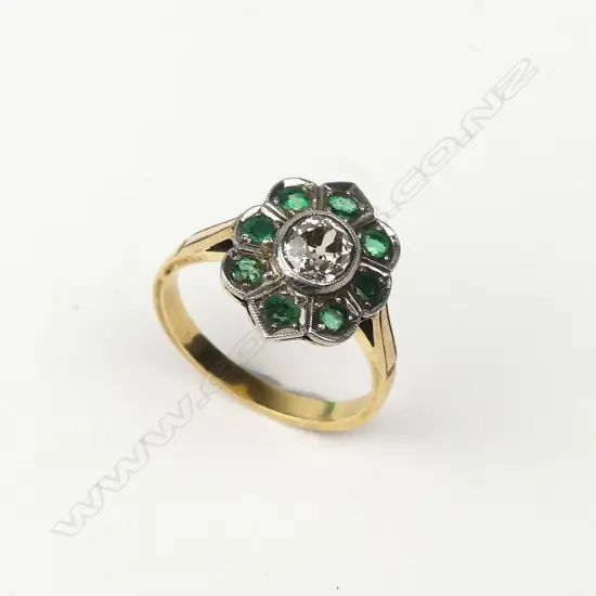An estate 18ct gold platinum diamond and emerald ring