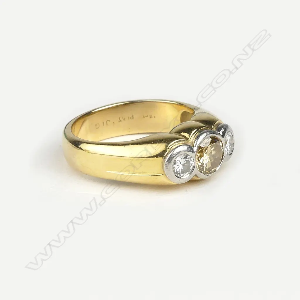 An 18ct gold platinum and three stone diamond ring Image 1++