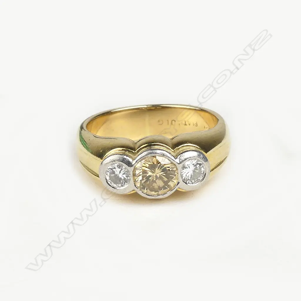 An 18ct gold platinum and three stone diamond ring Image 1++