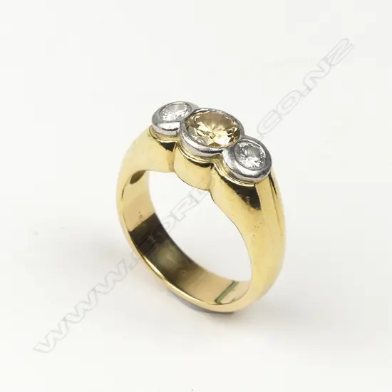 An 18ct gold platinum and three stone diamond ring
