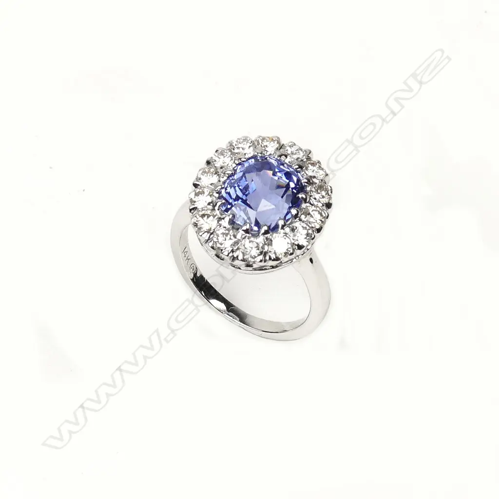 A 14ct white gold sapphire and diamond cluster ring Image 1++