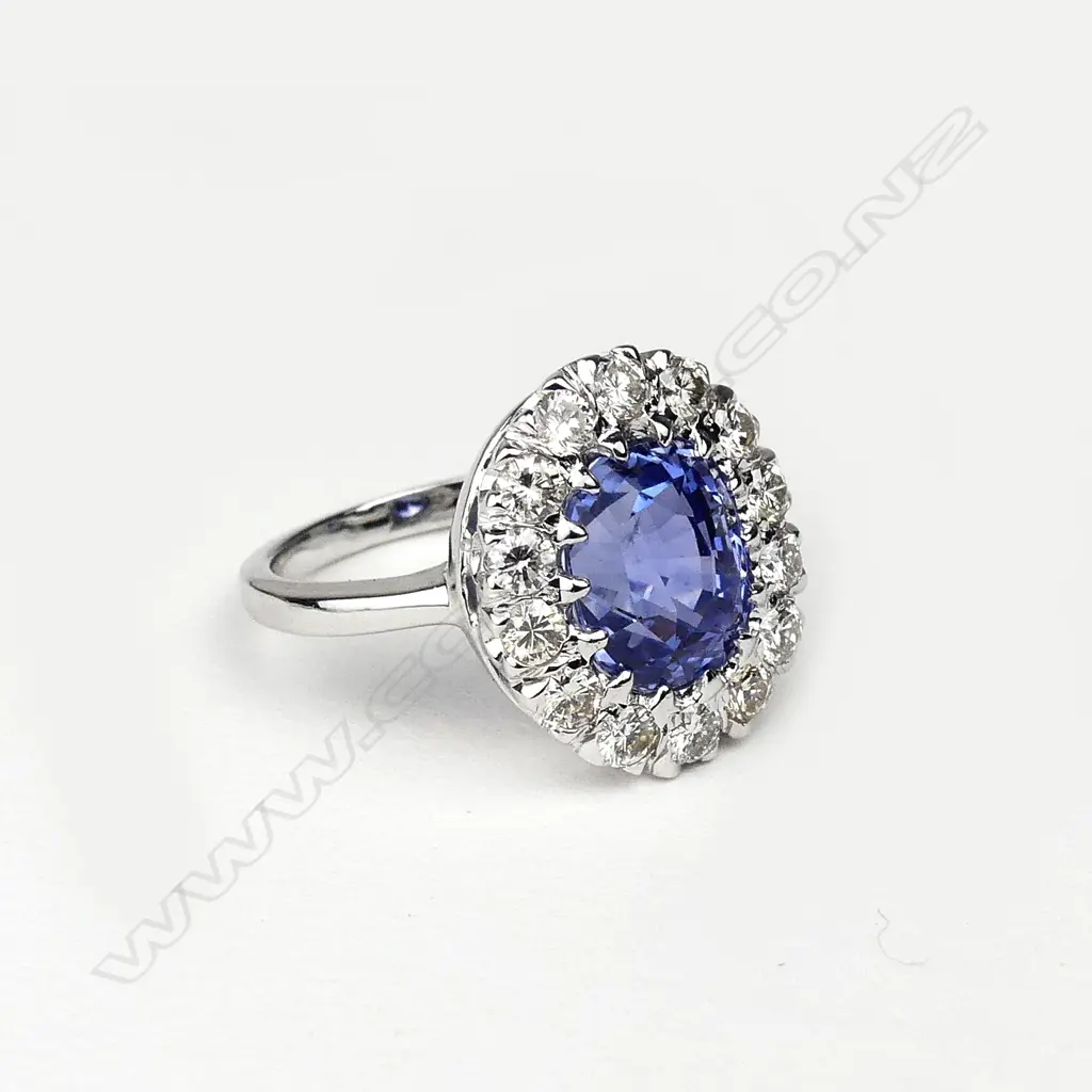 A 14ct white gold sapphire and diamond cluster ring Image 1++
