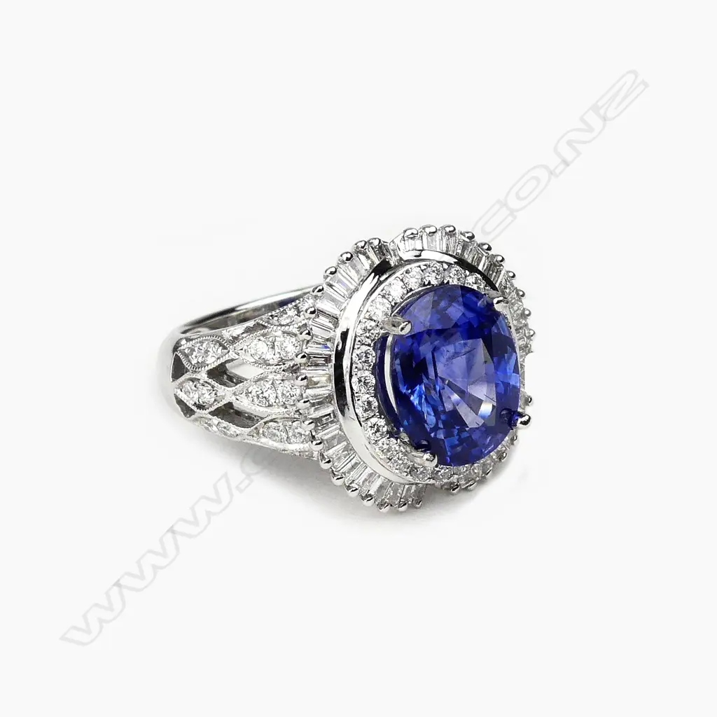 An 18ct white gold sapphire and diamond cluster ring Image 1++