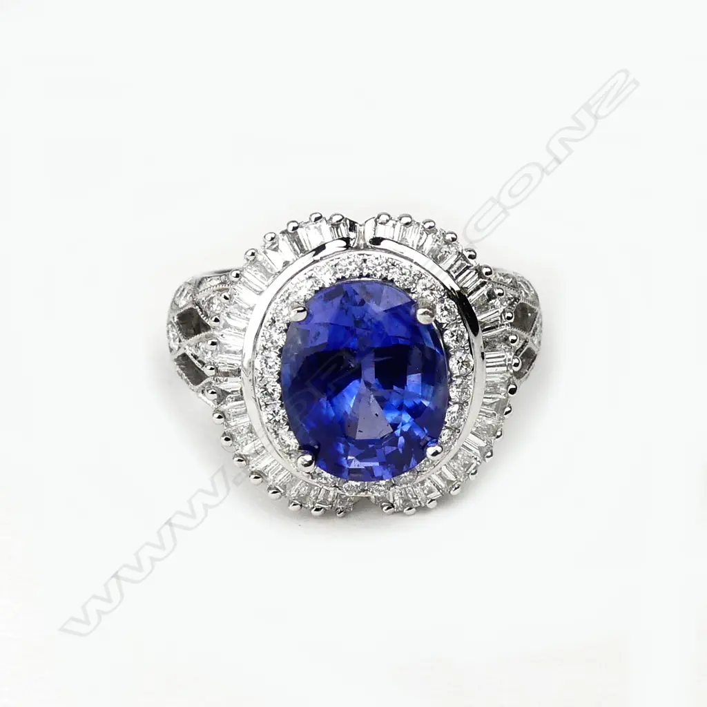 An 18ct white gold sapphire and diamond cluster ring Image 1++