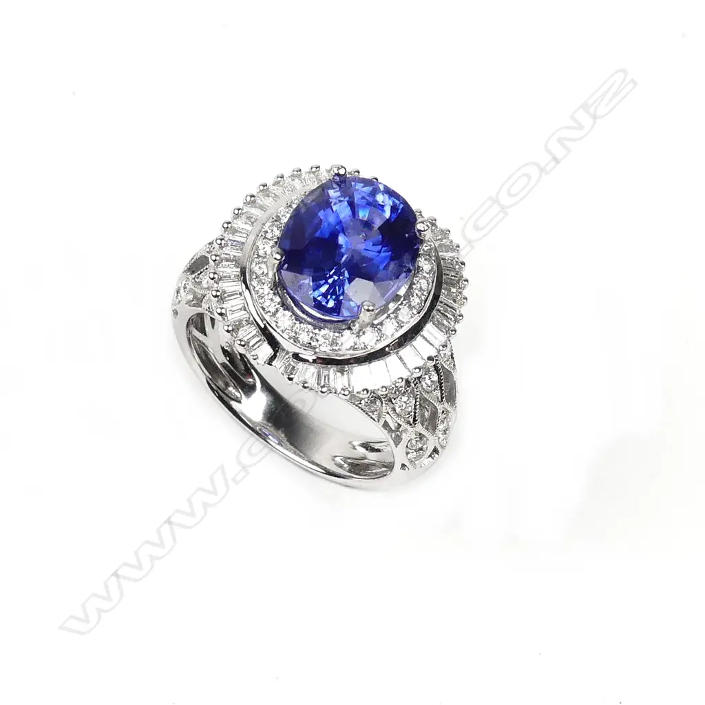 An 18ct white gold sapphire and diamond cluster ring Image 1++