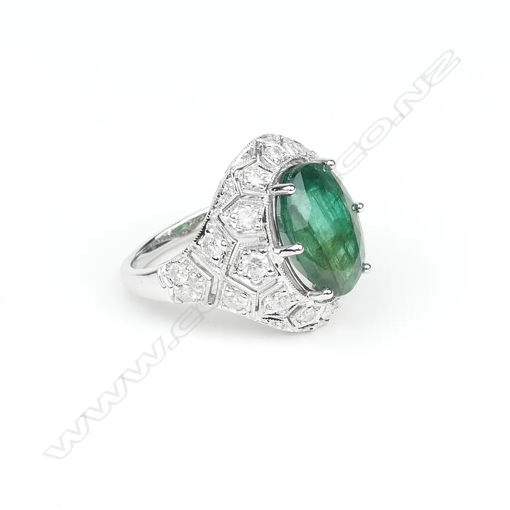An 18ct white gold emerald and diamond ring Image 1++
