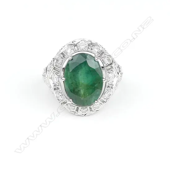 An 18ct white gold emerald and diamond ring