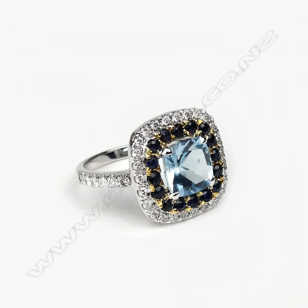 An 18ct white gold aquamarine diamond and sapphire ring Image 1++