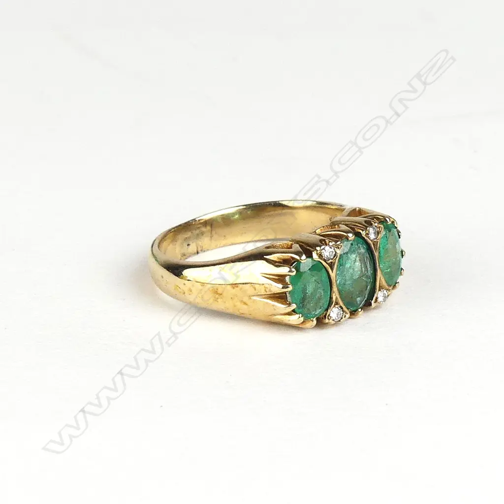 A 9ct gold emerald and diamond ring Image 1++