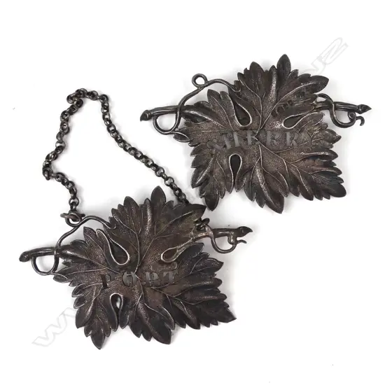 Two silver grape leaf decanter labels