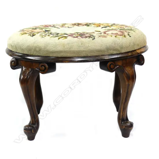 A c.1900 heavy scroll leg tapestry topped stool