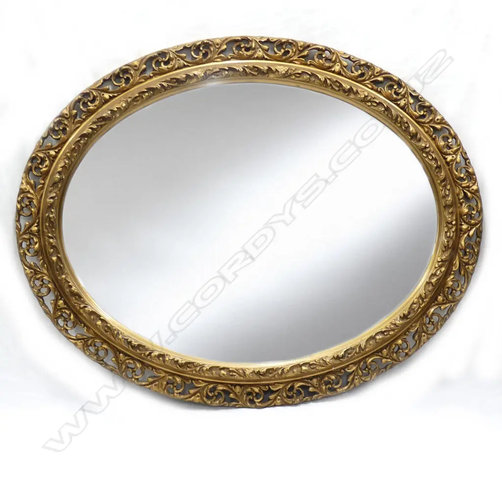 A 20thC large oval gilt plaster carved framed mirror Image 1++