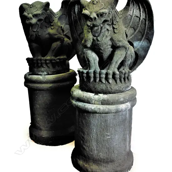 A pair of large seated house entrance gargoyles on plinths
