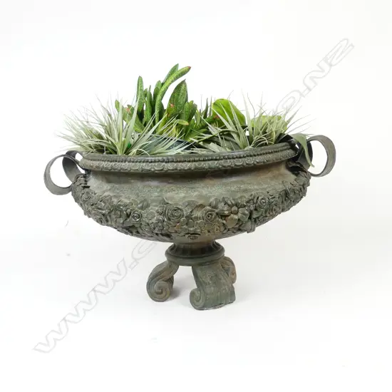 A cast iron garden urn on stand