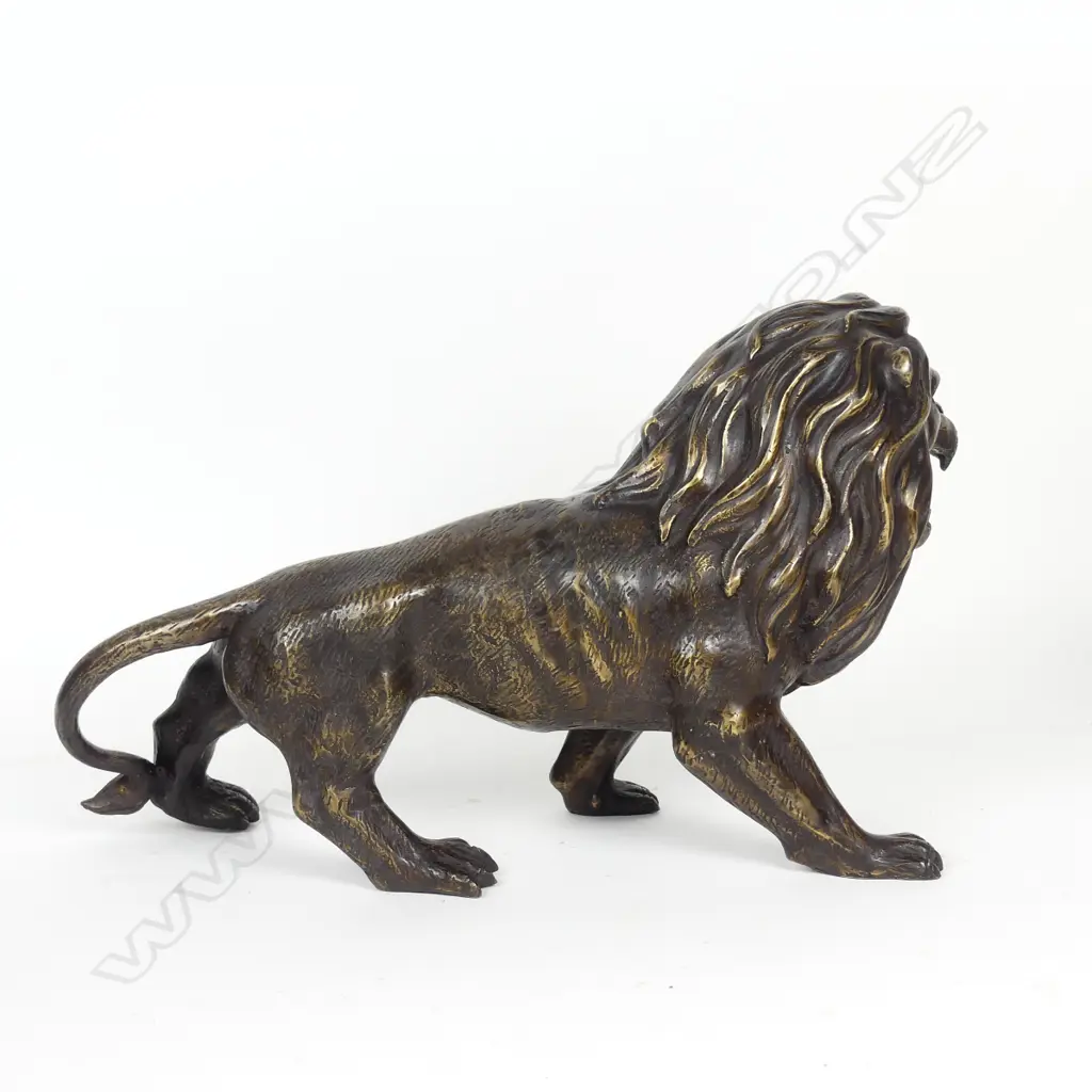 A bronze sculpture of a standing lion Image 1++