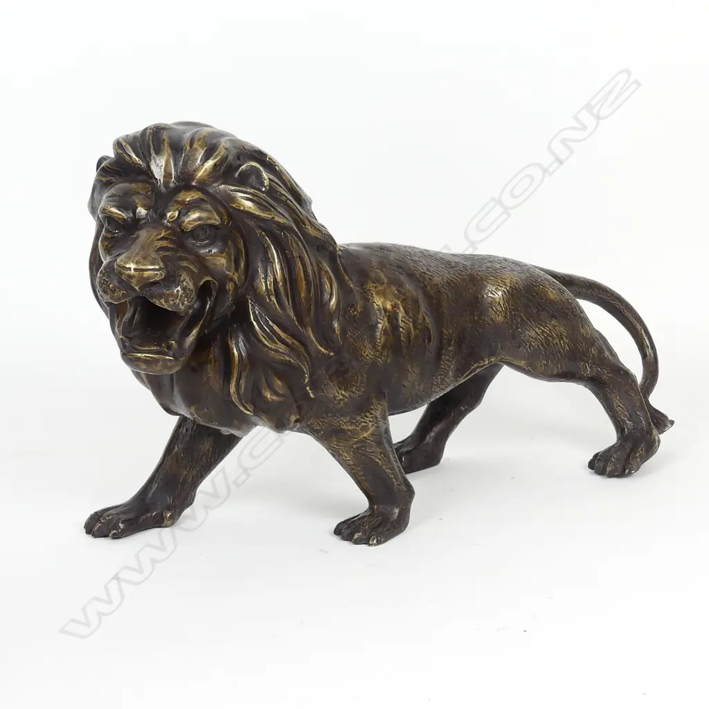 A bronze sculpture of a standing lion Image 1++