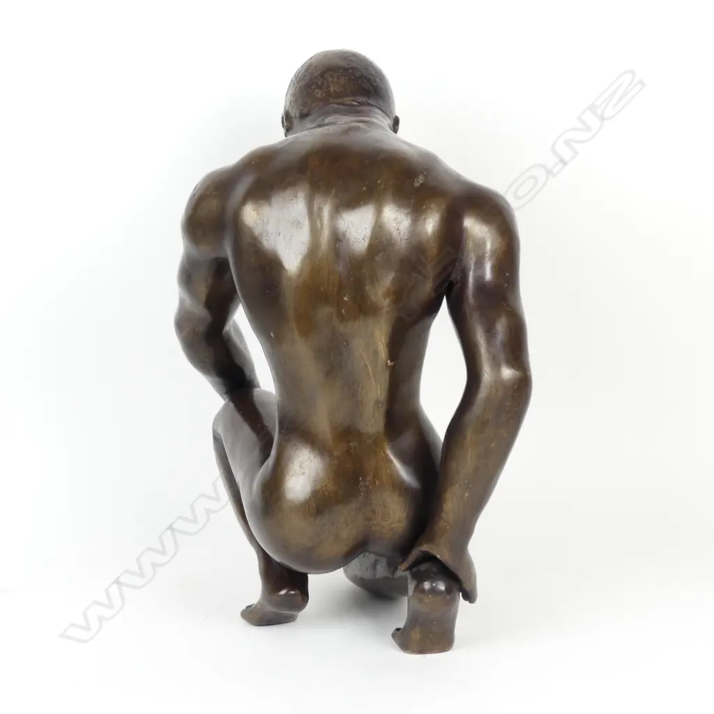 A bronze sculpture of a young man Image 1++