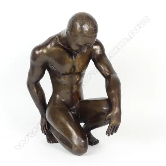 A bronze sculpture of a young man