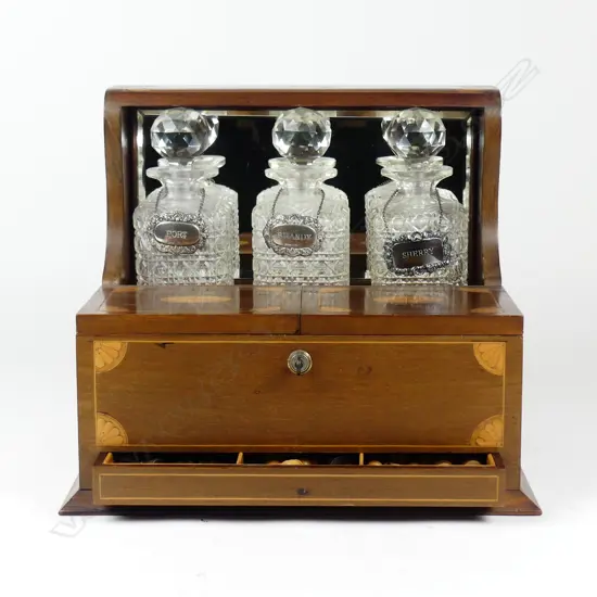 An Edwardian Sheraton revival mahogany games tantalus