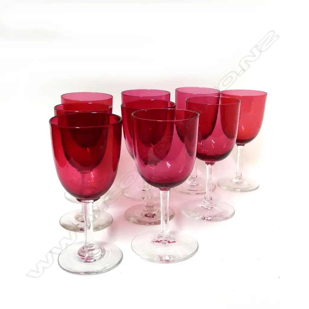 A set of nine cranberry glass stemmed port wine glasses Image 1++