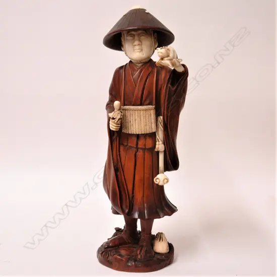 A good old Japanese carved boxwood and ivory large figure of a puppy seller