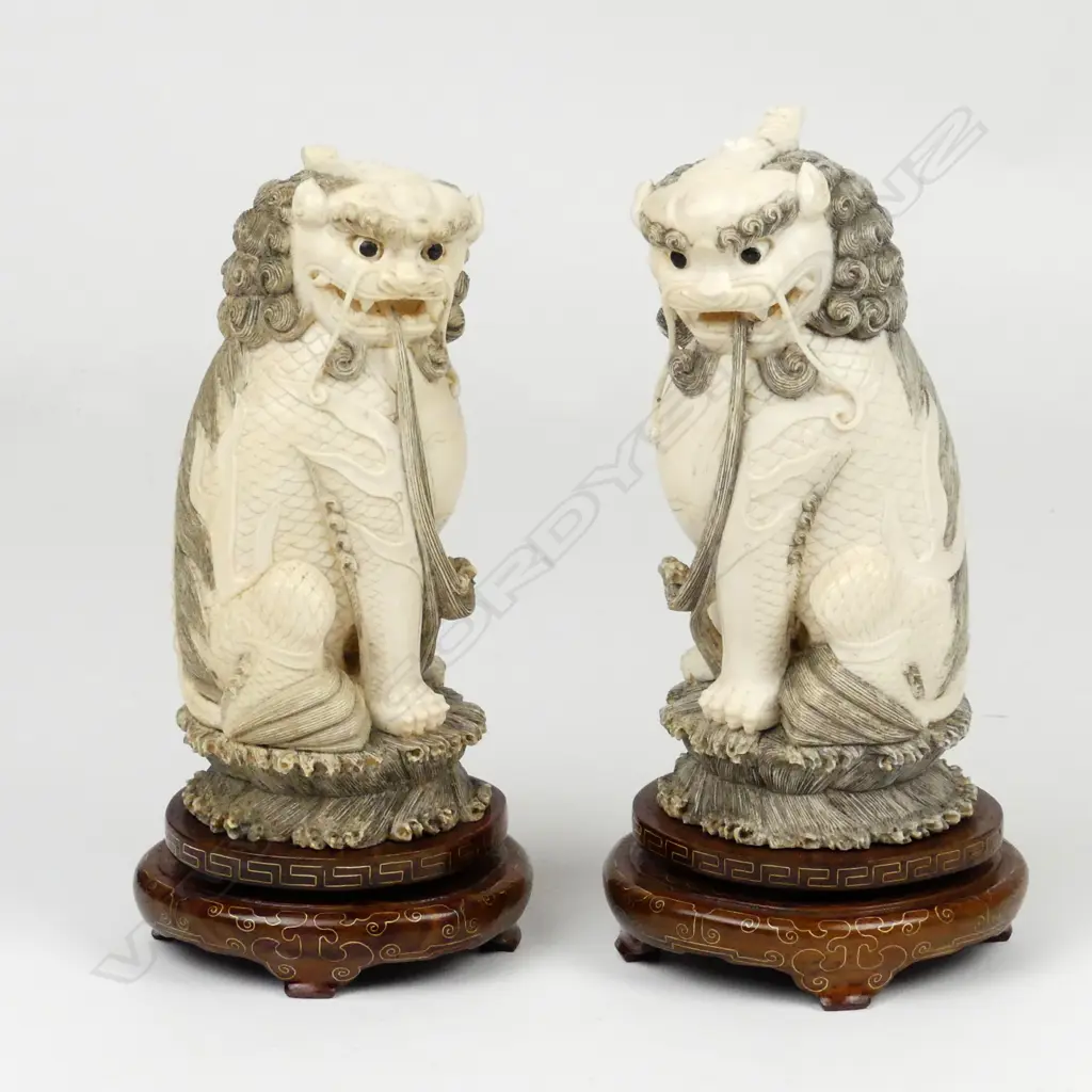 A pair of Chinese carved ivory xiezhi lion dogs Image 1++