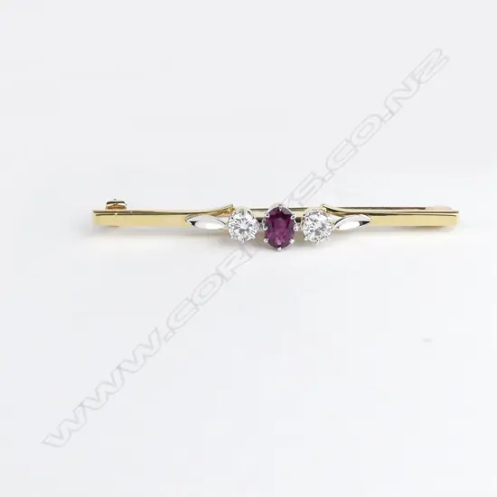 A lady's vintage 18ct. yellow and white gold ruby and diamond set bar brooch