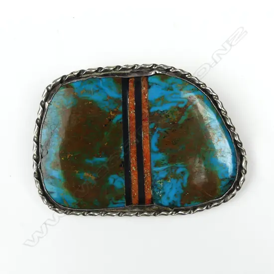 A large turquoise and silver belt buckle