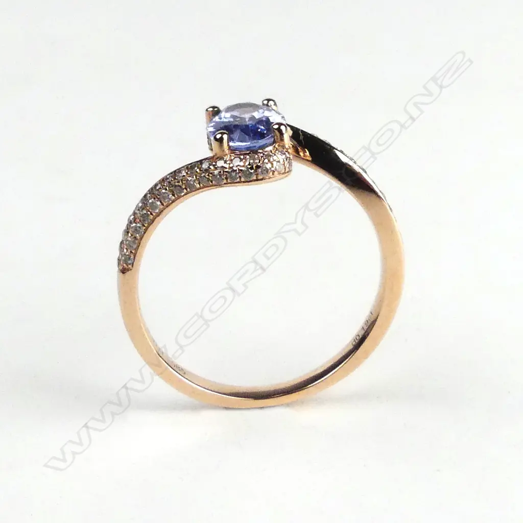 A 14ct rose gold sapphire and diamond ring Image 1++