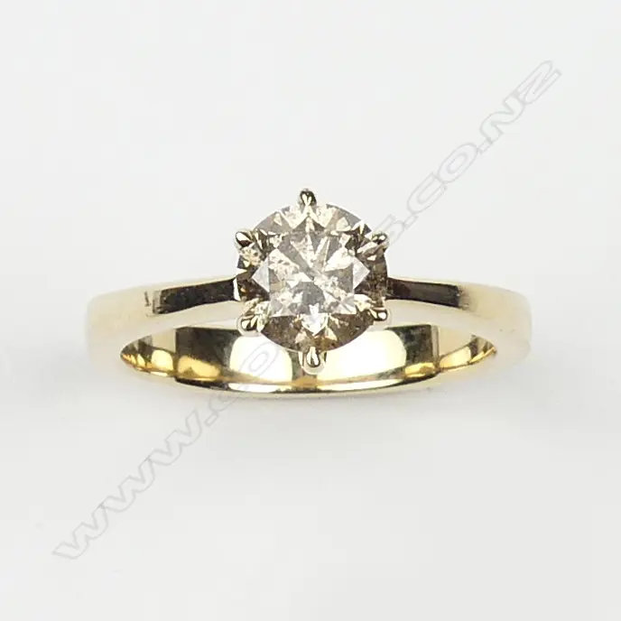 A 14ct yellow gold and diamond solitaire ring Image 1++